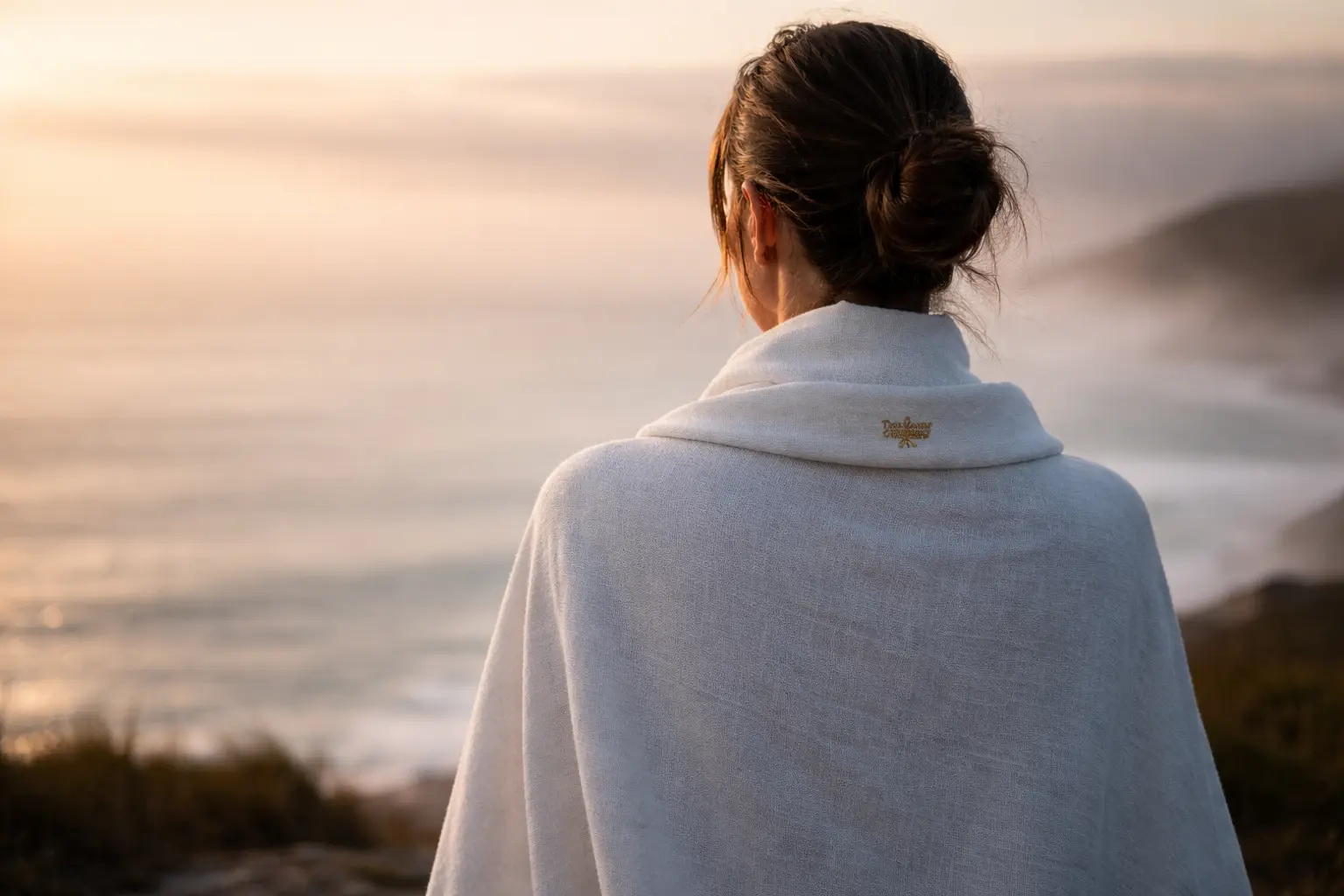 The 2026 Whycation Trend Journey Opener Solitary traveler at sunrise coastal horizon looking out, starting their mindful journey in The 2026 'Whycation' Trend to rest your soul.