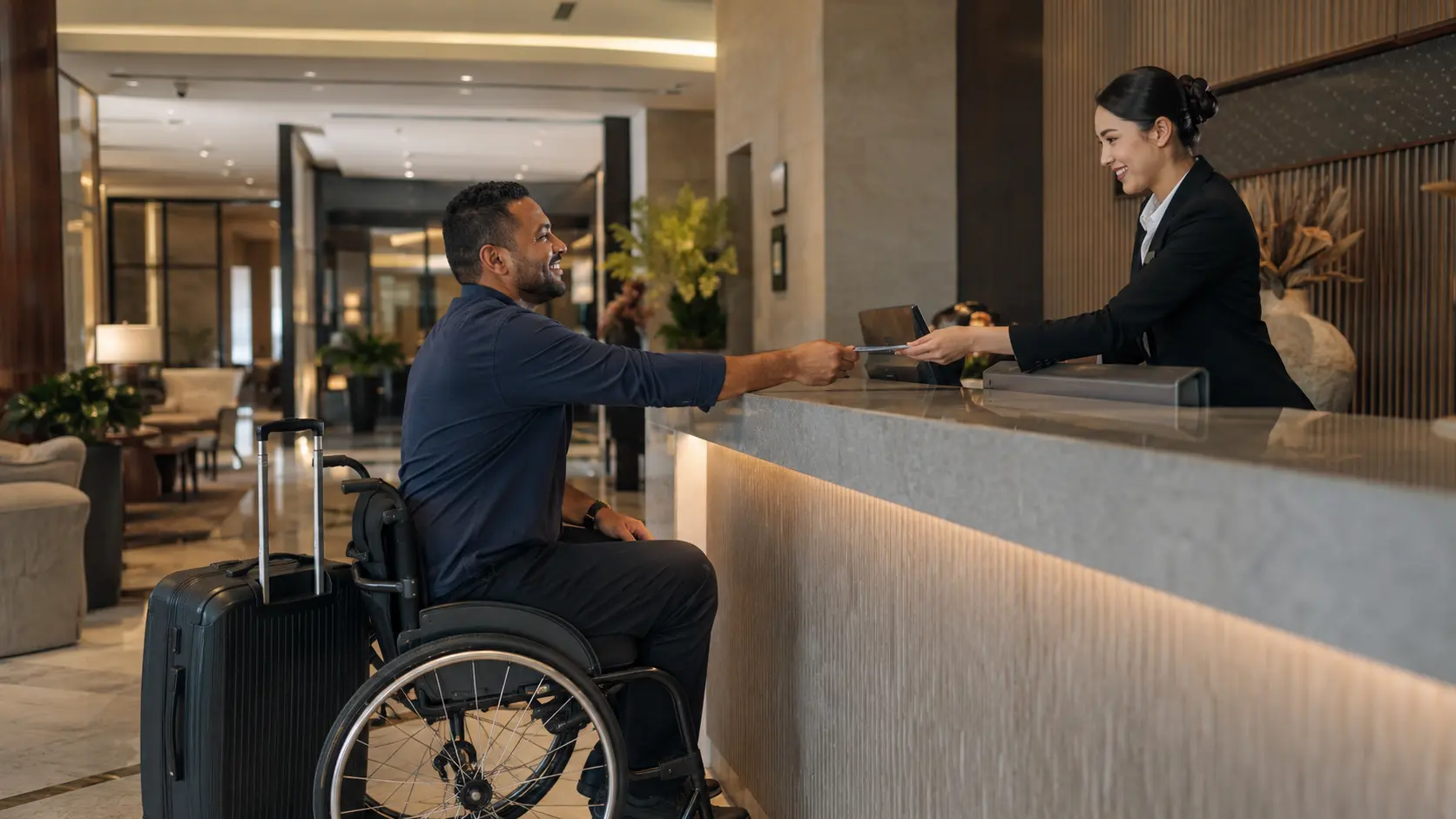 Agoda review 2026 — accessible hotel welcome with staff assisting a wheelchair guest